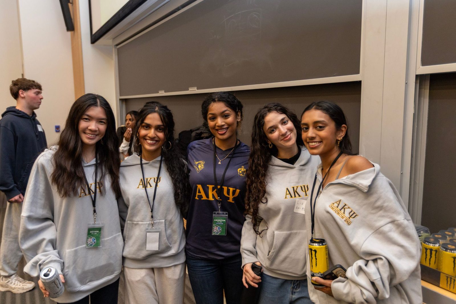 Omicron Tau members in chapter hoodies at a chapter event