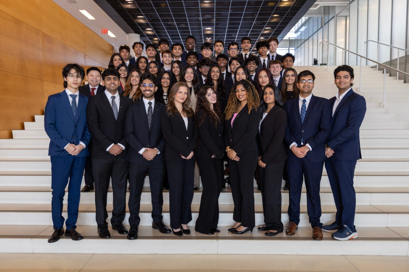 The Omicron Tau chapter gathered on the staircase in business attire
